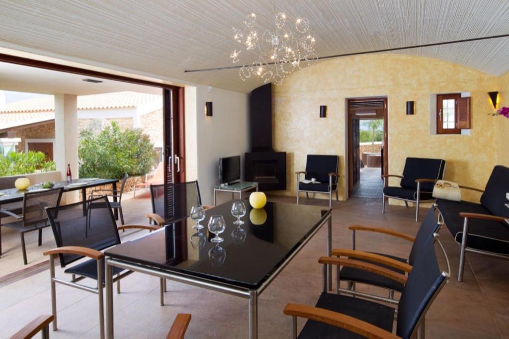 een woonkamer met een tafel en stoelen bij CAN NOVES - Villa de 2 suites (3) in Sant Francesc Xavier