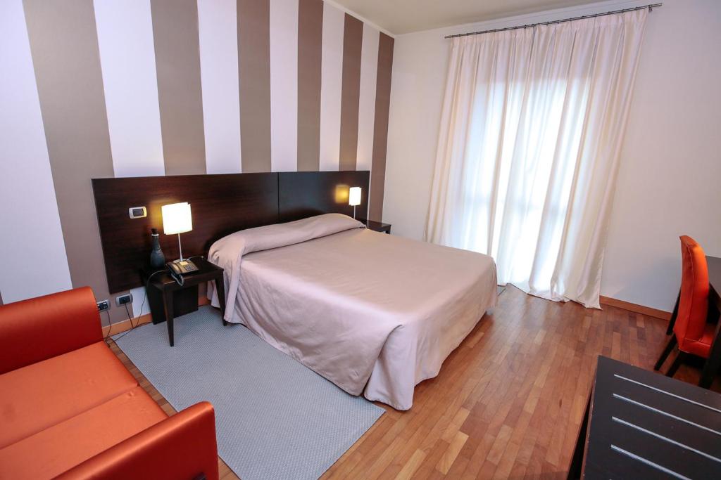 Postel nebo postele na pokoji v ubytování Hotel Aleramo