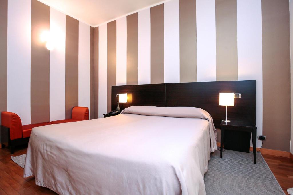 Postel nebo postele na pokoji v ubytování Hotel Aleramo