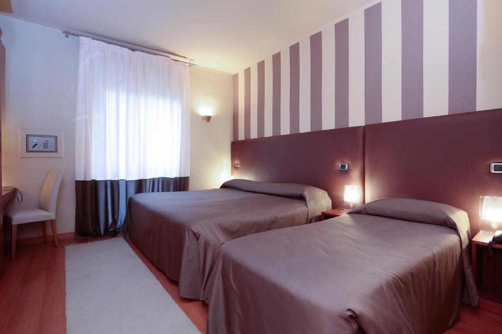 Postel nebo postele na pokoji v ubytování Hotel Aleramo