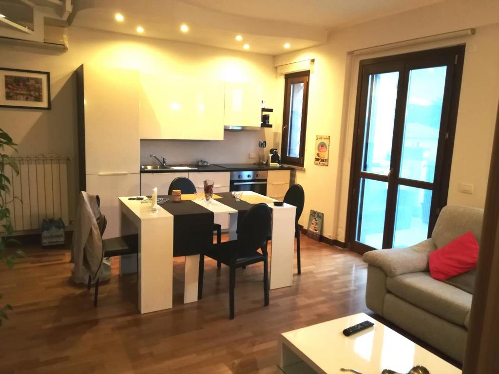 a kitchen and living room with a table and chairs at Aurelia House in Rome