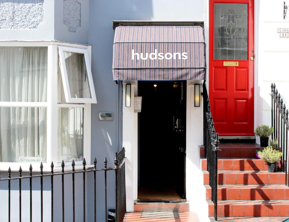 a red door and a black entrance to a house at Hudsons in Brighton & Hove