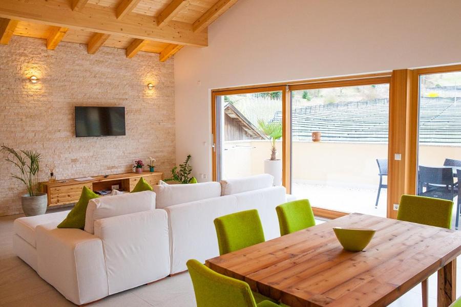 ein Wohnzimmer mit einem weißen Sofa und einem Holztisch in der Unterkunft El Paradiso in Naturns