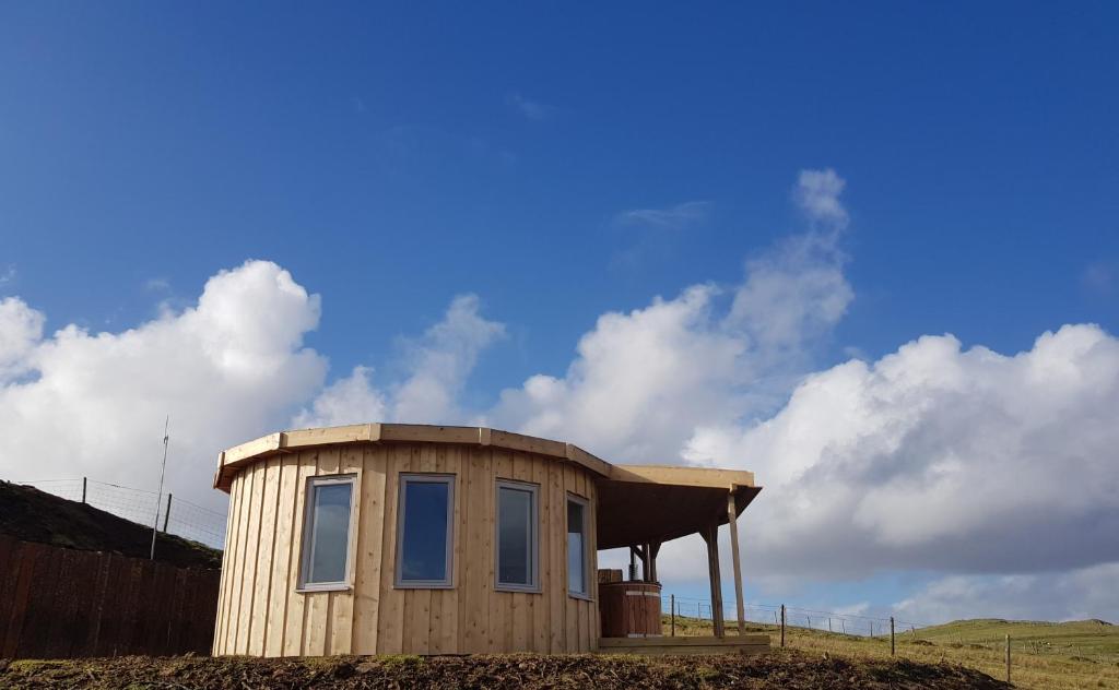 a small house on top of a hill at Skye Cabins in Skeabost