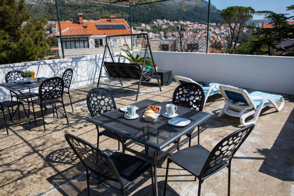a group of tables and chairs on a patio at Apartments Nada in Dubrovnik