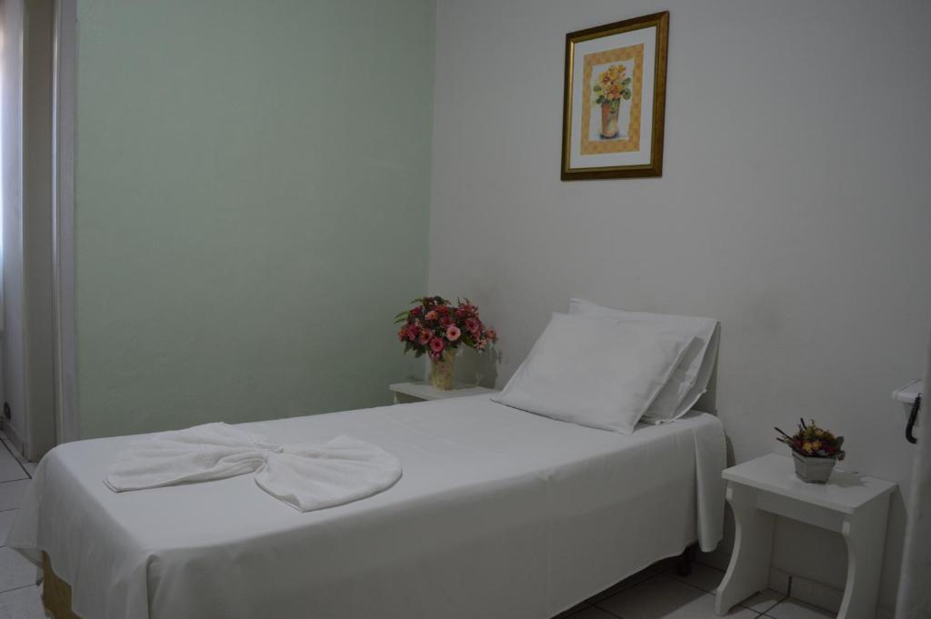 Postel nebo postele na pokoji v ubytování Hotel Confort Maringá