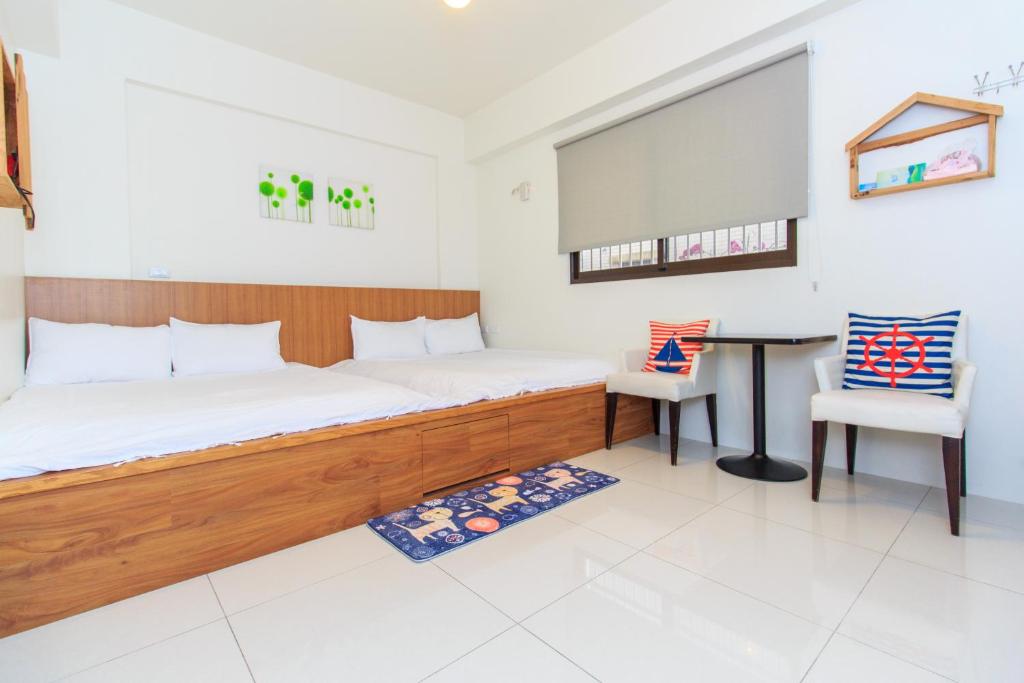 Postel nebo postele na pokoji v ubytování Yilan Dongshan Cypress B&B