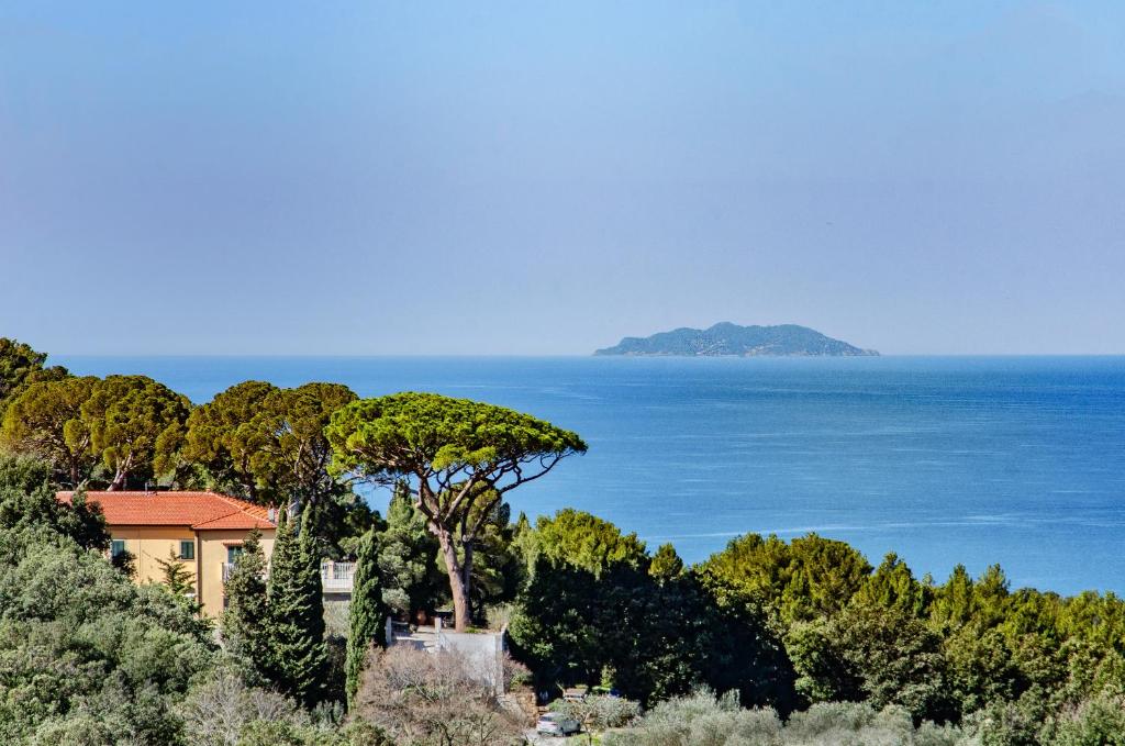 a house on a hill next to the ocean at Villa Eugenia in Livorno