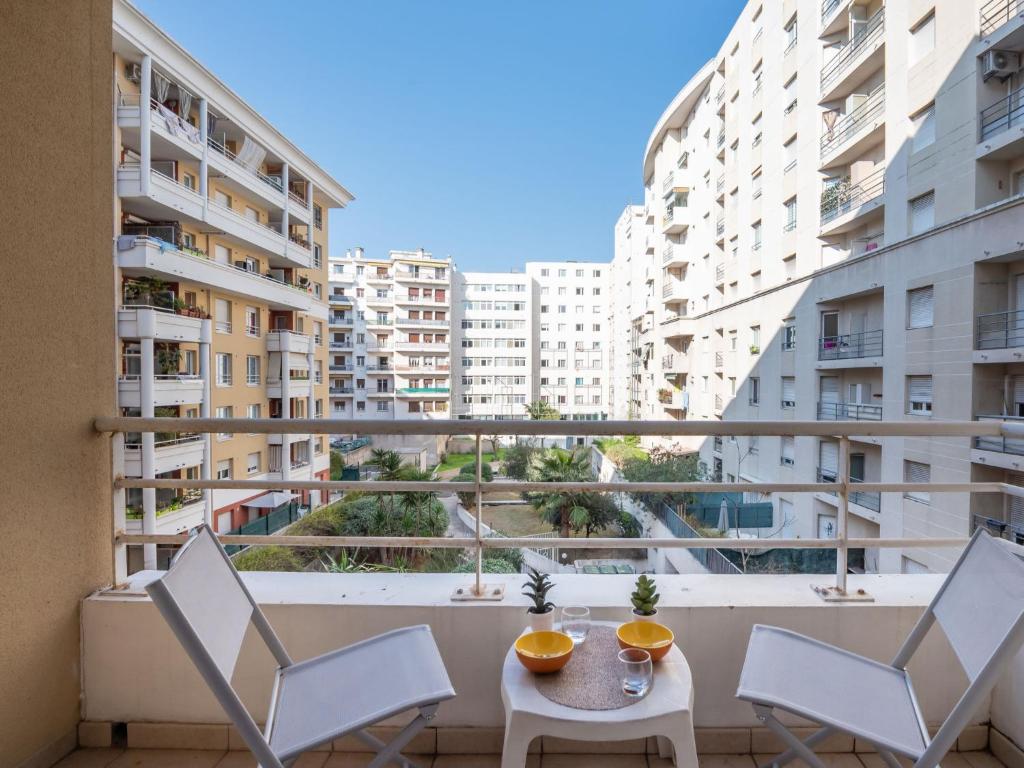a balcony with a table and chairs and buildings at Apartment Le Kappas in Nice