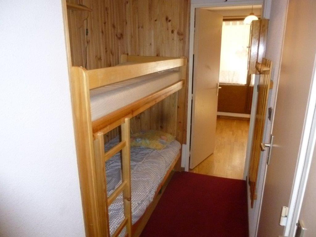 a bunk bed in a small room with a door at Bouffée d Oxygène in Le Seignus