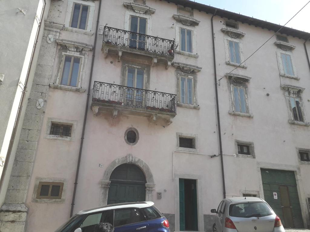 a building with two cars parked in front of it at Emidio e Carmen in Pescocostanzo
