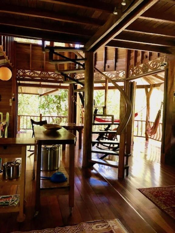 a living room with a table and some chairs at Las Ranitas in Puerto Viejo