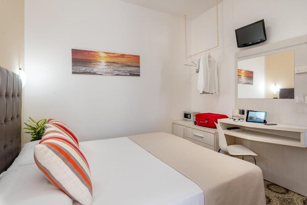 Postel nebo postele na pokoji v ubytování Hotel Maria Serena