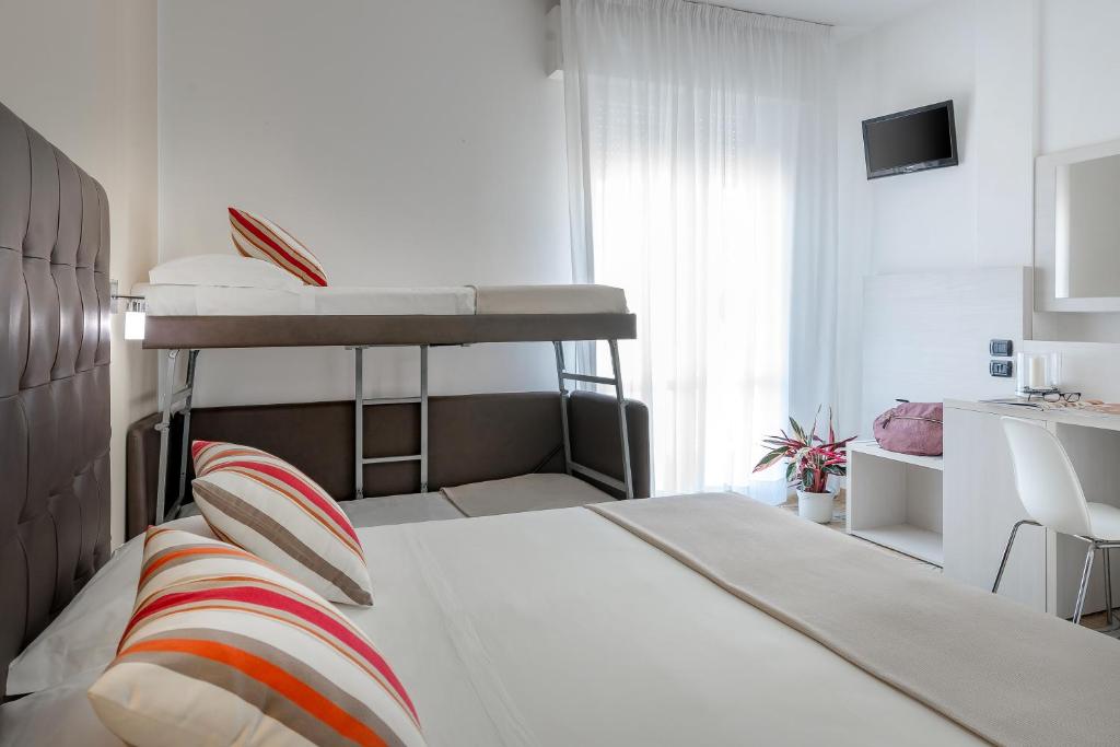 Postel nebo postele na pokoji v ubytování Hotel Maria Serena