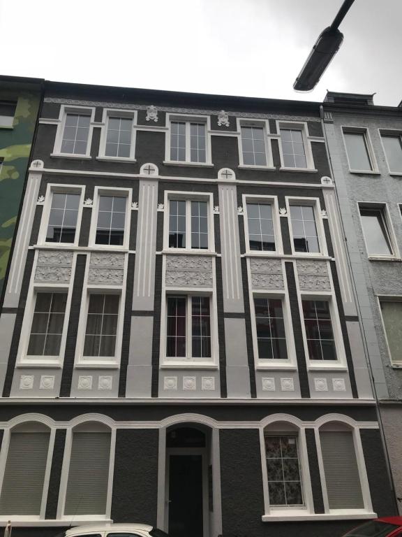 a black and white building with white windows at Deluxe Wohnungen Dortmund Mitte in Dortmund