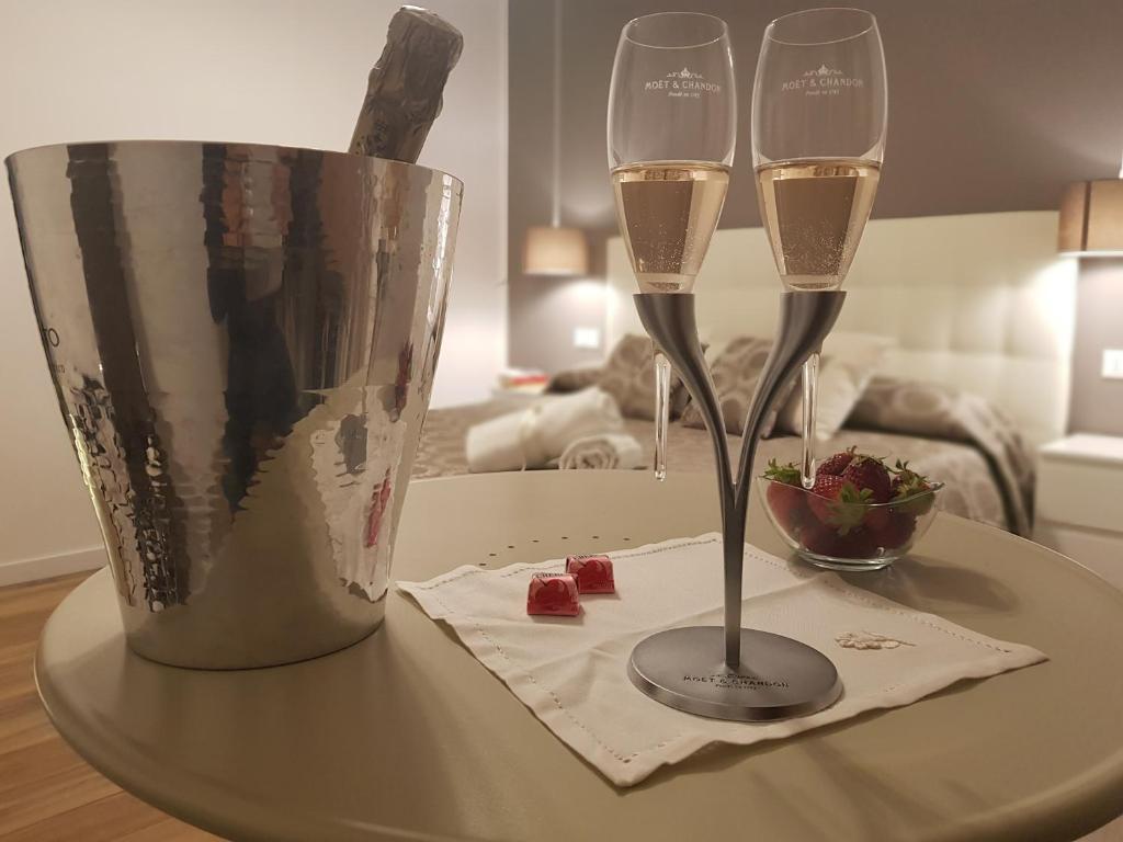 dos copas de vino sentadas en una mesa en Gocce di Girgenti - comfort suites, en Agrigento