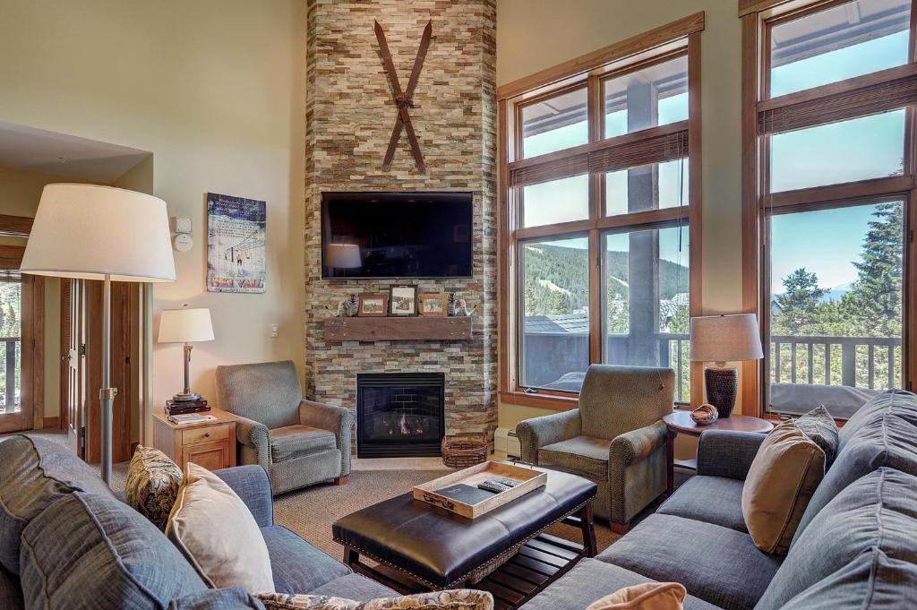 a living room with a couch and a fireplace at 8890 The Springs Condo in Keystone