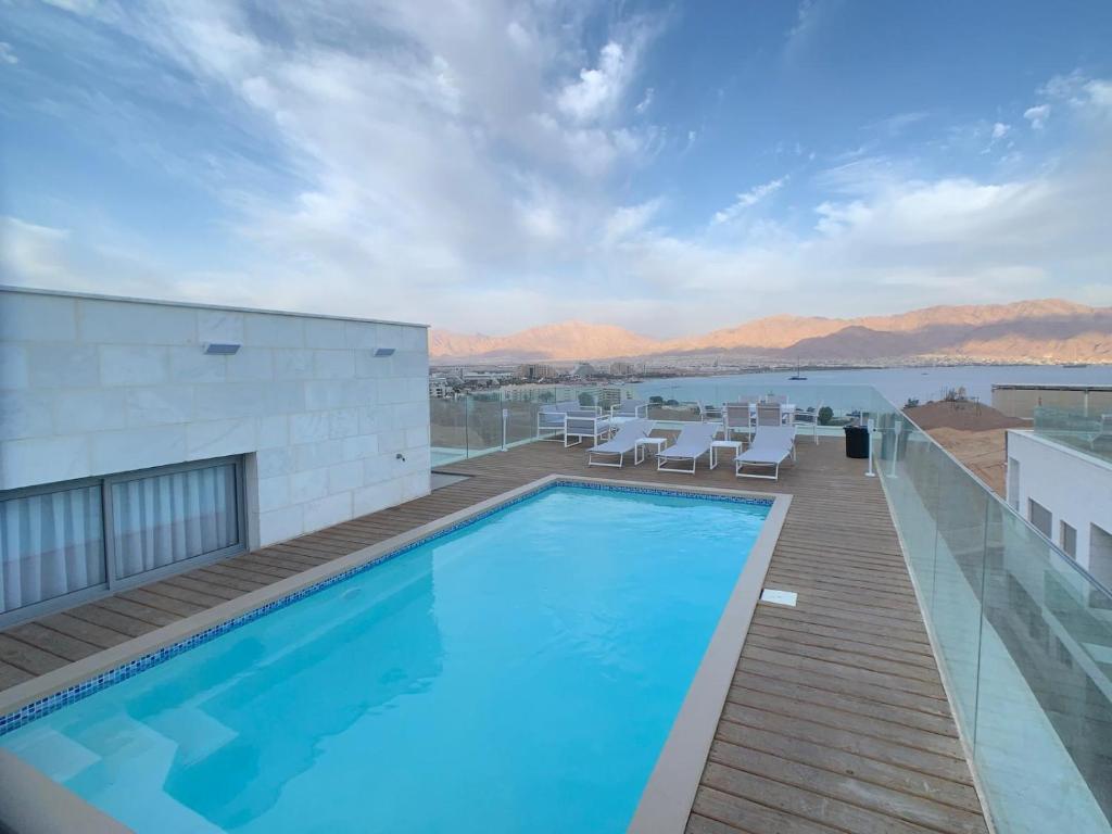 a swimming pool on the roof of a building at villalis in Eilat