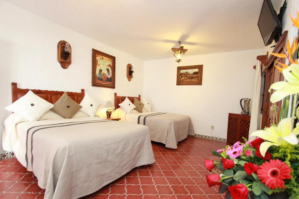 Postel nebo postele na pokoji v ubytování Hotel Mesón del Rosario