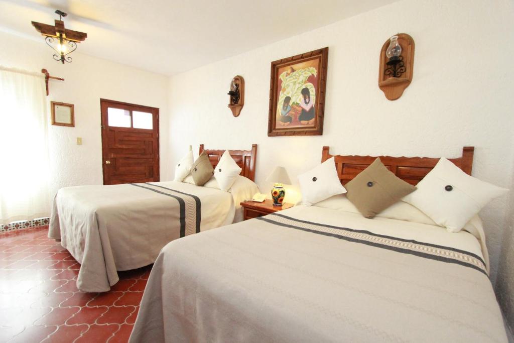 Postel nebo postele na pokoji v ubytování Hotel Mesón del Rosario