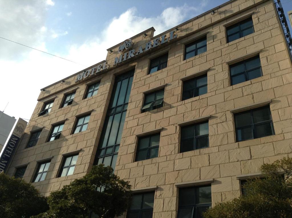 a building with a sign on top of it at Mirabell Motel in Busan