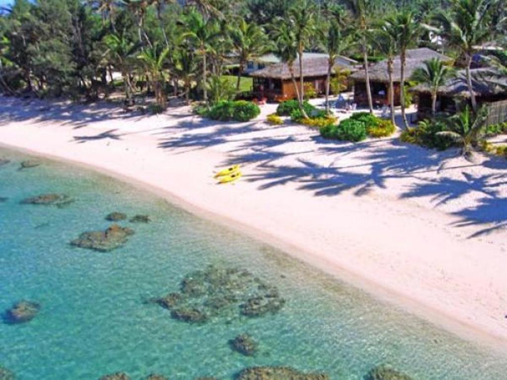 an aerial view of a beach with a resort at Rarotonga Beach Bungalows in Rarotonga