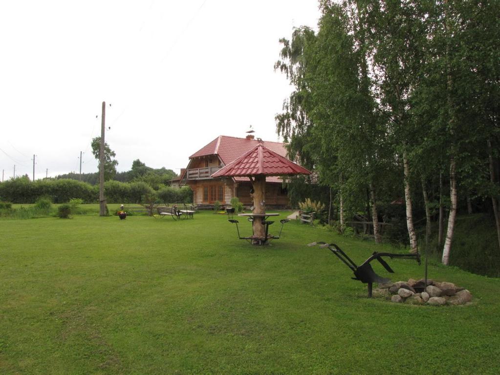 a park with a gazebo and a bench in the grass at Laba Oma in Cēsis