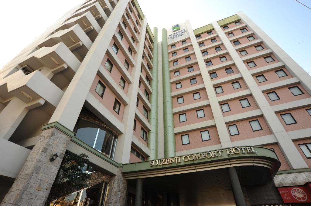 a building with a sign that readsstudent conference hotel at Suizenji Comfort Hotel in Kumamoto