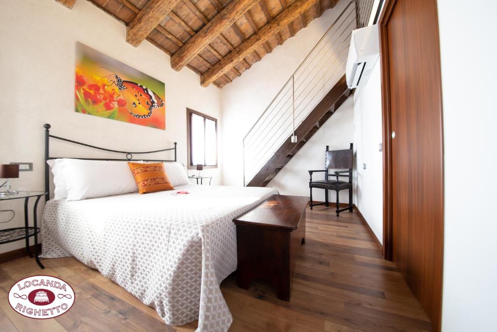 een slaapkamer met een bed en een trap bij LOCANDA RIGHETTO in Quinto di Treviso
