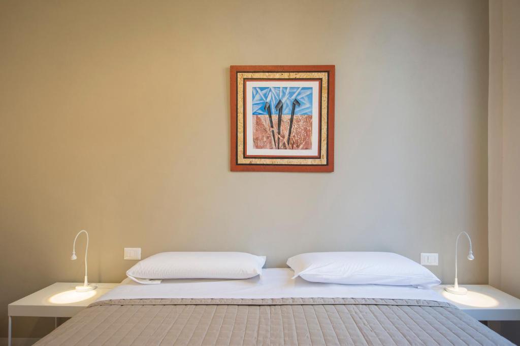 Postel nebo postele na pokoji v ubytování Piazza Paradiso Accommodation
