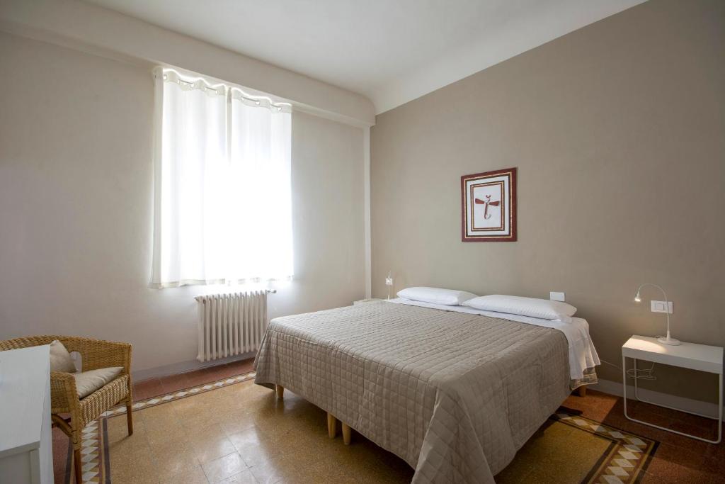 Postel nebo postele na pokoji v ubytování Piazza Paradiso Accommodation