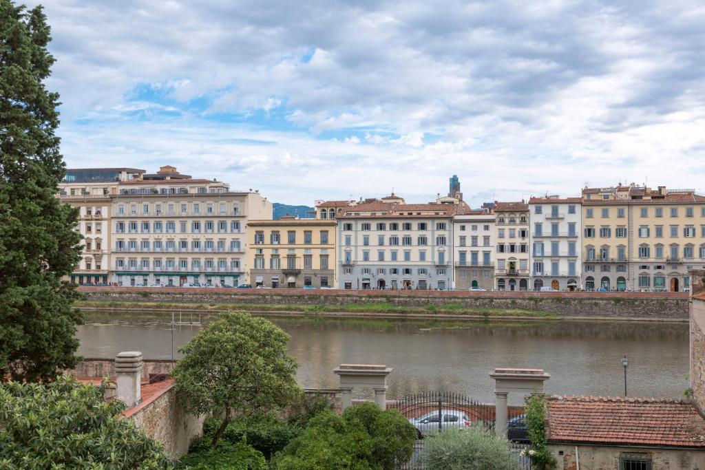 a view of a city with a river and buildings at B&B Stupido Hotel in Florence
