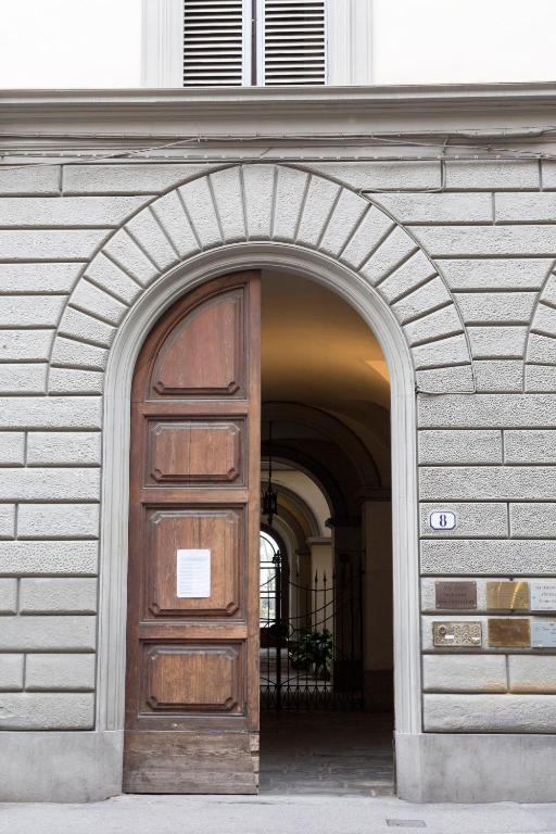 an archway with a wooden door in a building at B&B Stupido Hotel in Florence