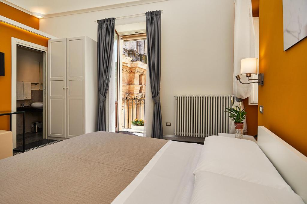 a bedroom with a large bed and a window at Donna Teresa Guest House in Lecce