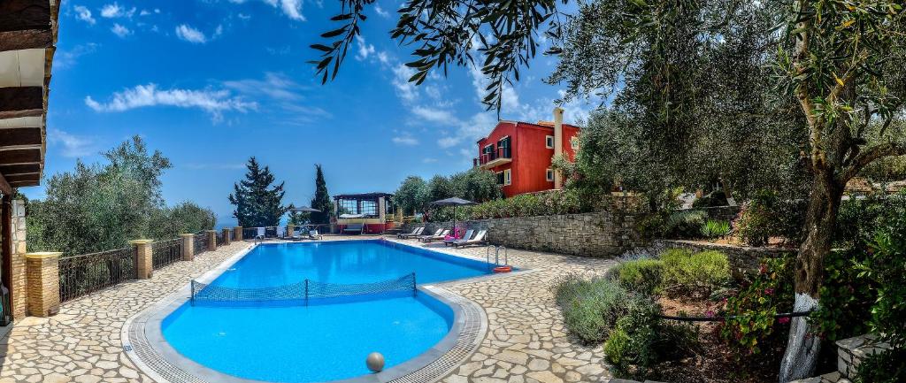 a large blue swimming pool in front of a building at Bella Vista Villas & Suites in Gaios