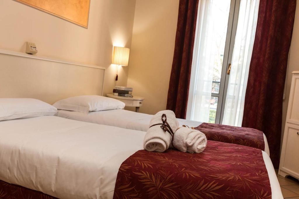 Postel nebo postele na pokoji v ubytování Hotel Le Mura