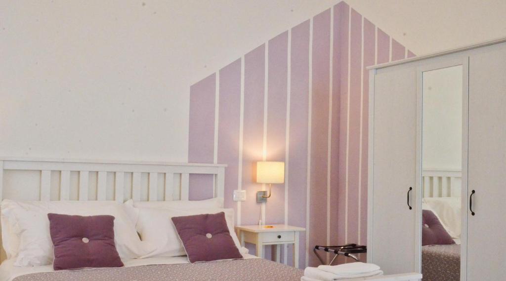 Postel nebo postele na pokoji v ubytování Petit Hotel