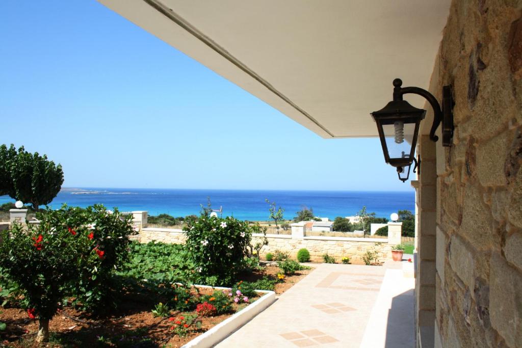 a street light on a wall with the ocean in the background at Romantica Apartments in Falasarna