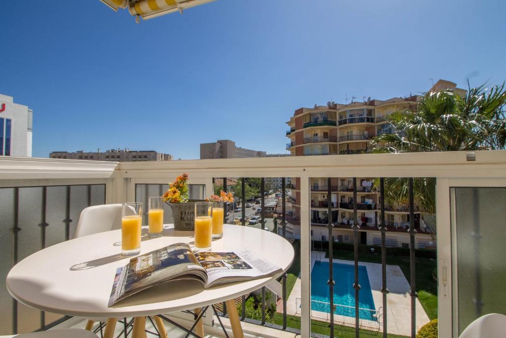 a white table on a balcony with a view of a building at Erisa 68 by IVI Real Estate in Torremolinos