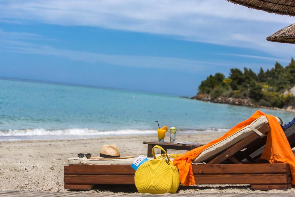 a beach with a tent and a table on the beach at Olympion Sunset Halkidiki in Fourka