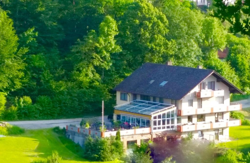 a large building with a solar roof on top of it at Hotel-Pension Haus Hubertus in Weigendorf