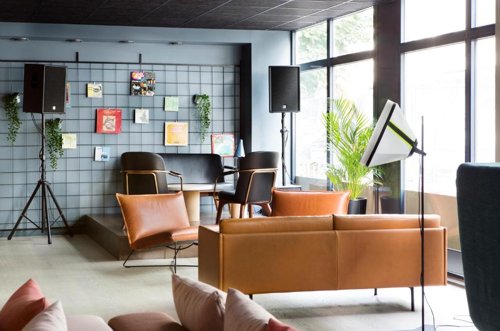 a waiting room with leather chairs and a table at Comfort Hotel Bergen in Bergen