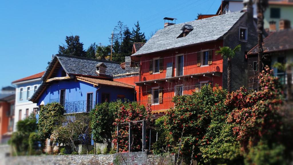 an orange house with a gray roof at Case di Sotto, House & Breakfast in Locarno