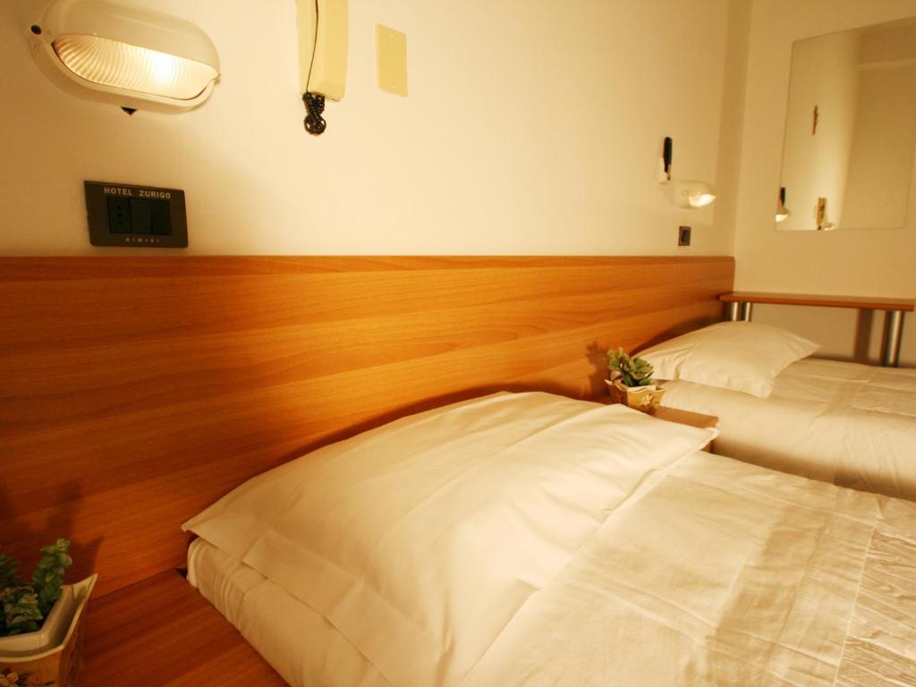 Postel nebo postele na pokoji v ubytování Hotel Zurigo