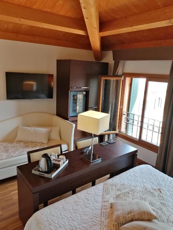 Postel nebo postele na pokoji v ubytování Albergo Minuetto