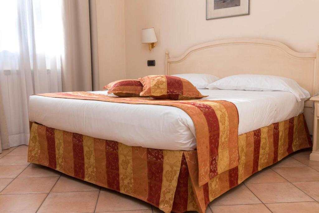 Postel nebo postele na pokoji v ubytování Hotel Le Mura