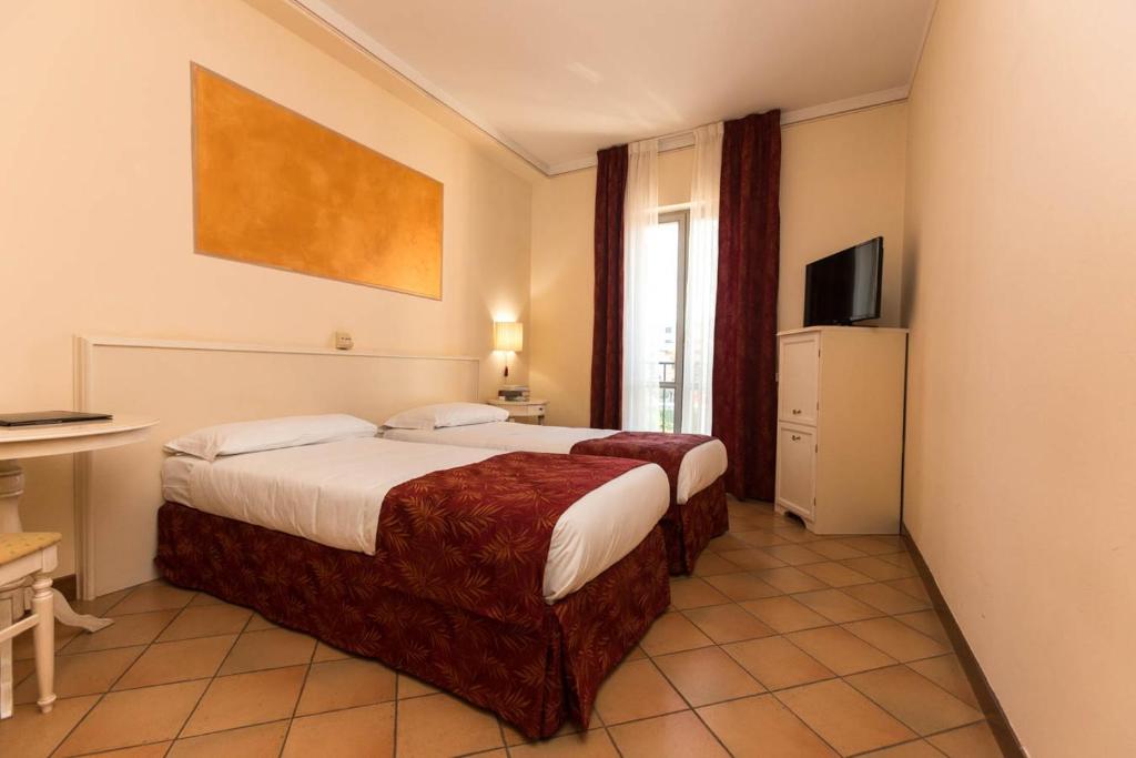 Postel nebo postele na pokoji v ubytování Hotel Le Mura