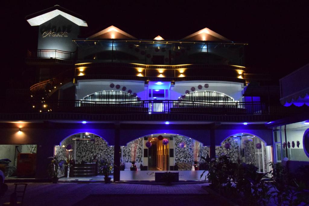 a building with blue lights on it at night at Hotel Agape in Mannar
