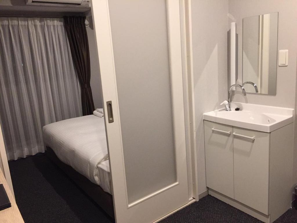 Koupelna v ubytování HOTEL STATE TENNOJI