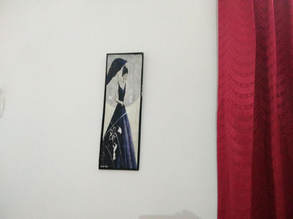 a picture of a woman hanging on a wall at Nunu Homestay Guruvayoor in Guruvāyūr